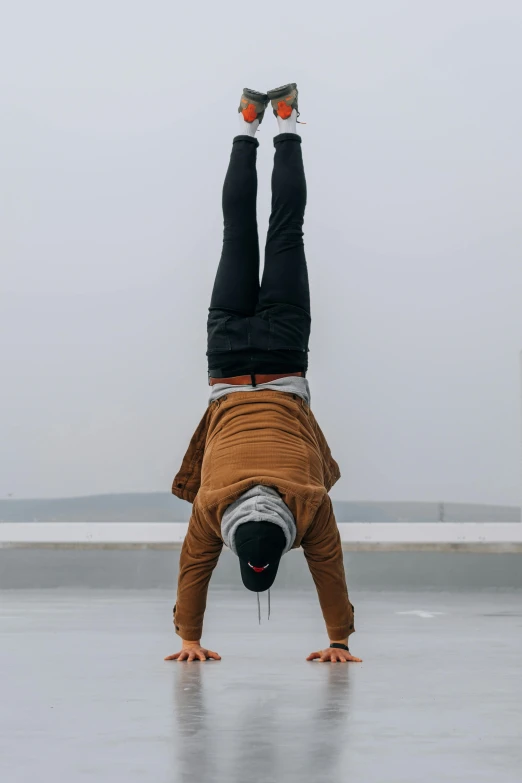 the man is doing a handstand with two legs