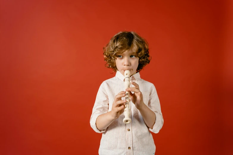 a  holding up a pipe on a red background