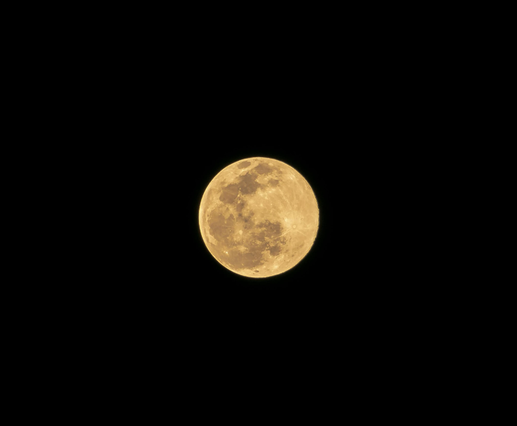 the full moon seen from across a black sky