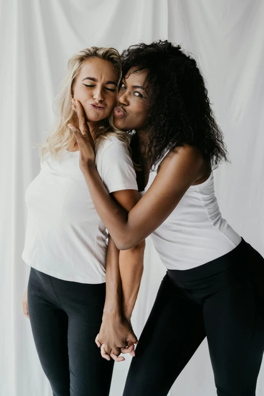 two women emce each other while wearing leggings