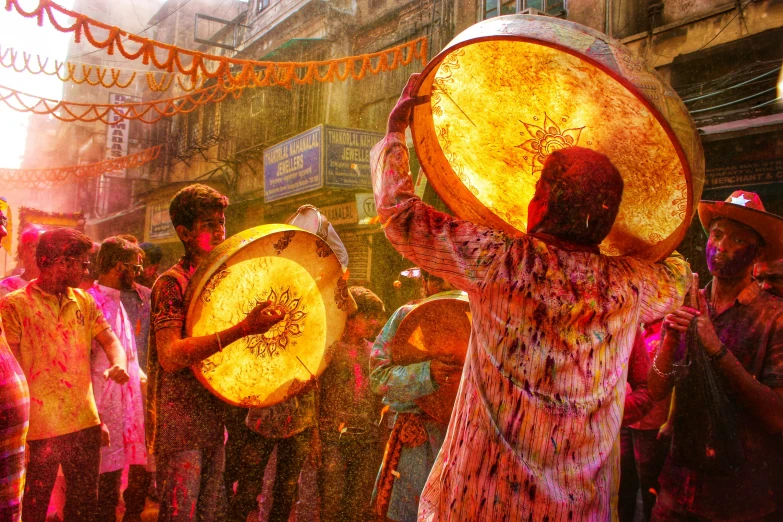 a group of people that are standing around with some drums