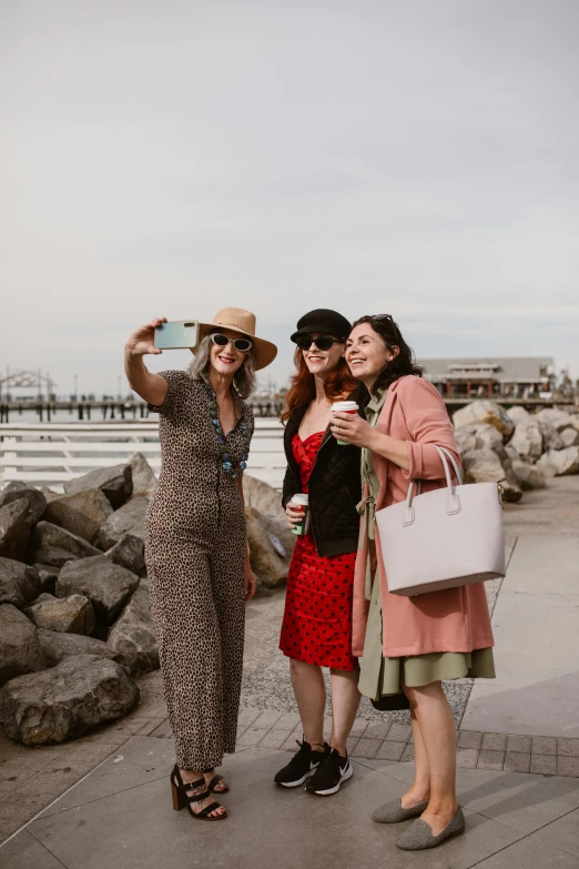 two woman taking pos of themselves on the boardwalk