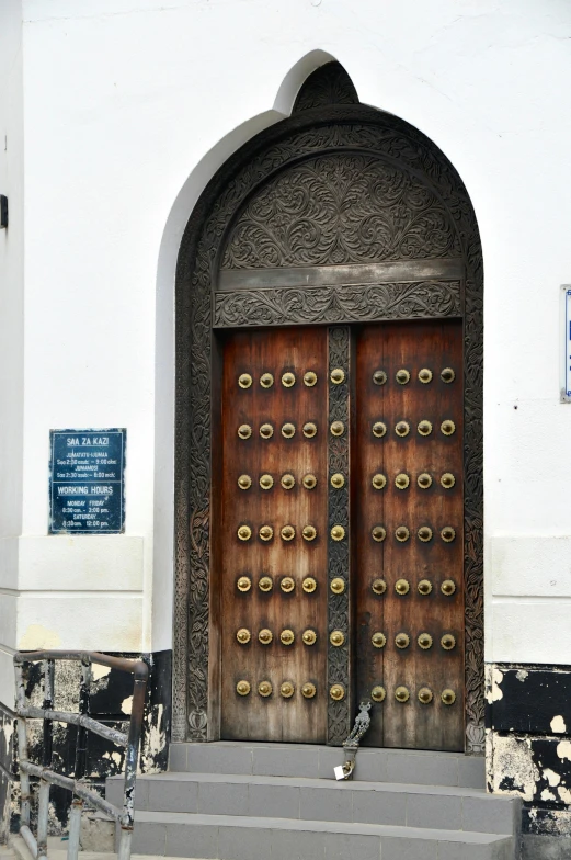 large doorways with metal handles are painted brown