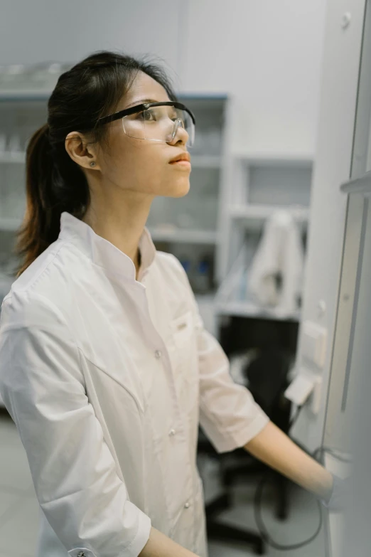 a woman working on soing in a white lab