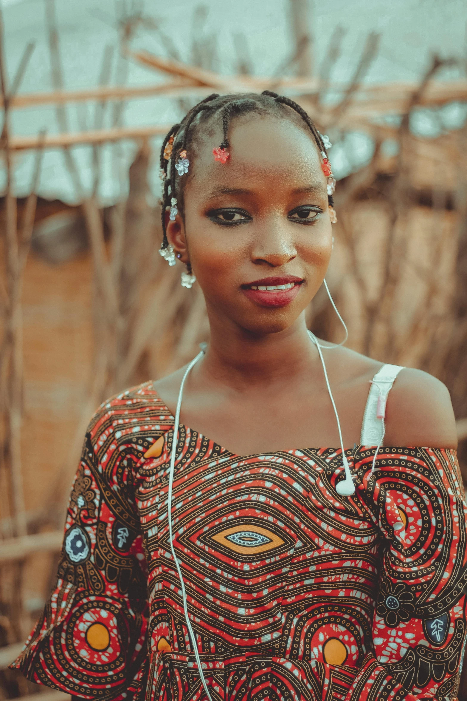 a young woman wearing an off - shoulder top and headpiece