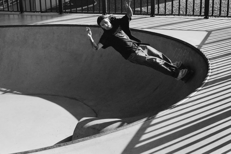 a person riding a skate board on a bowl