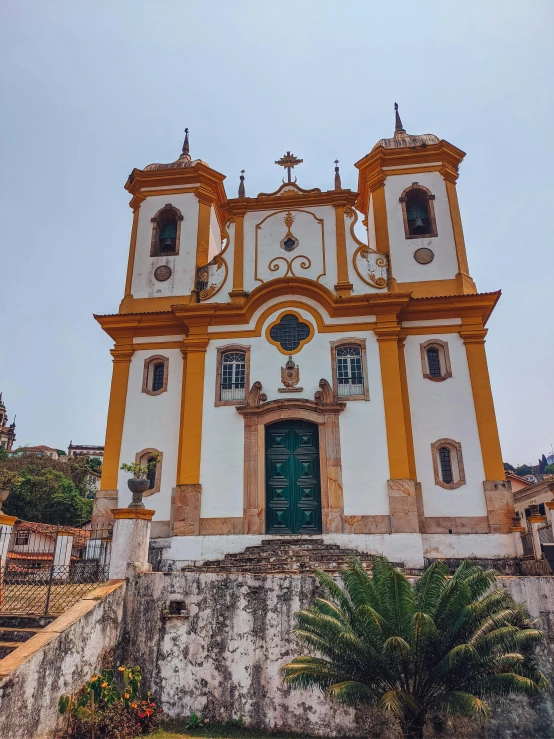 the exterior of a yellow and white church