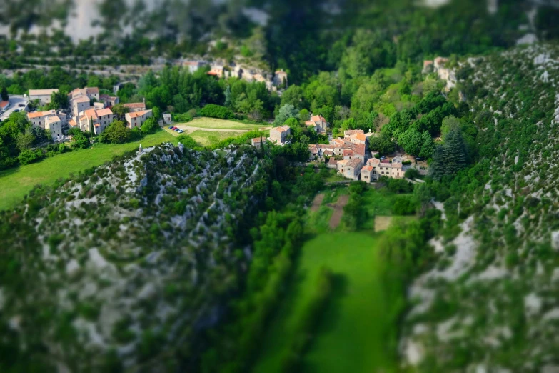 an aerial view of a town near a hillside