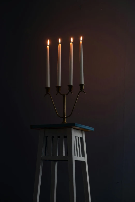 a tall ss - candela sits on a stool