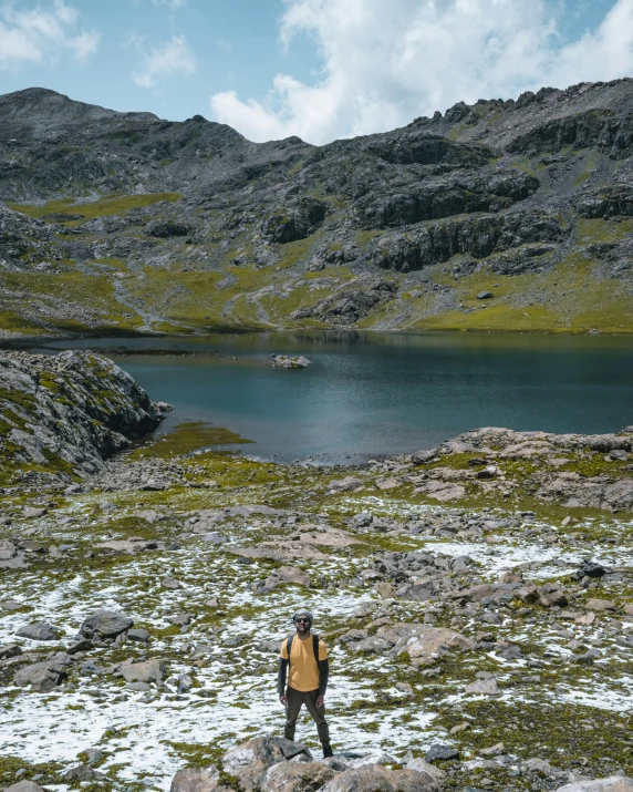 a person standing on the snow covered ground by water