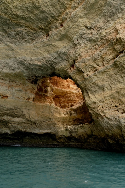 a rock face with a large window in it