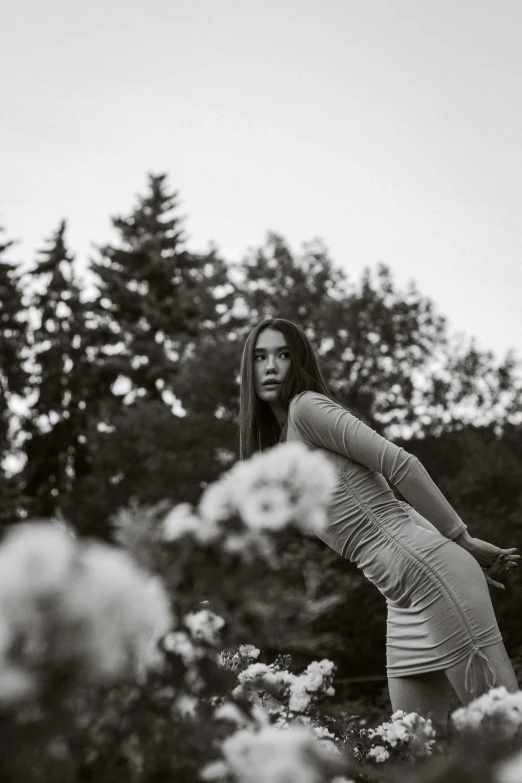 a black and white po of a woman in a field