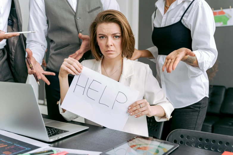 a woman holding a sign at her office