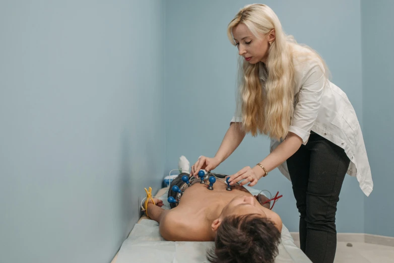 an adult being shown to perform a procedure