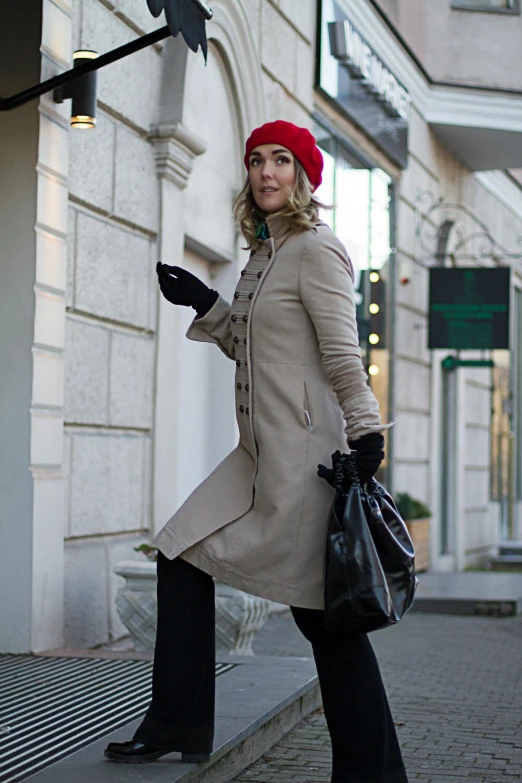 a woman is walking on a street and holding an umbrella