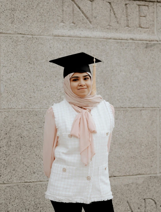 a young woman wearing a graduation cap and scarf