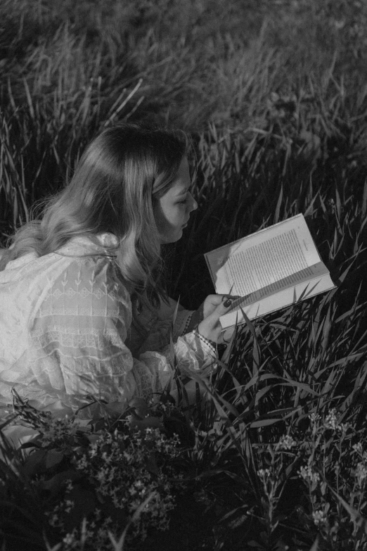 the  is reading a book in the grass