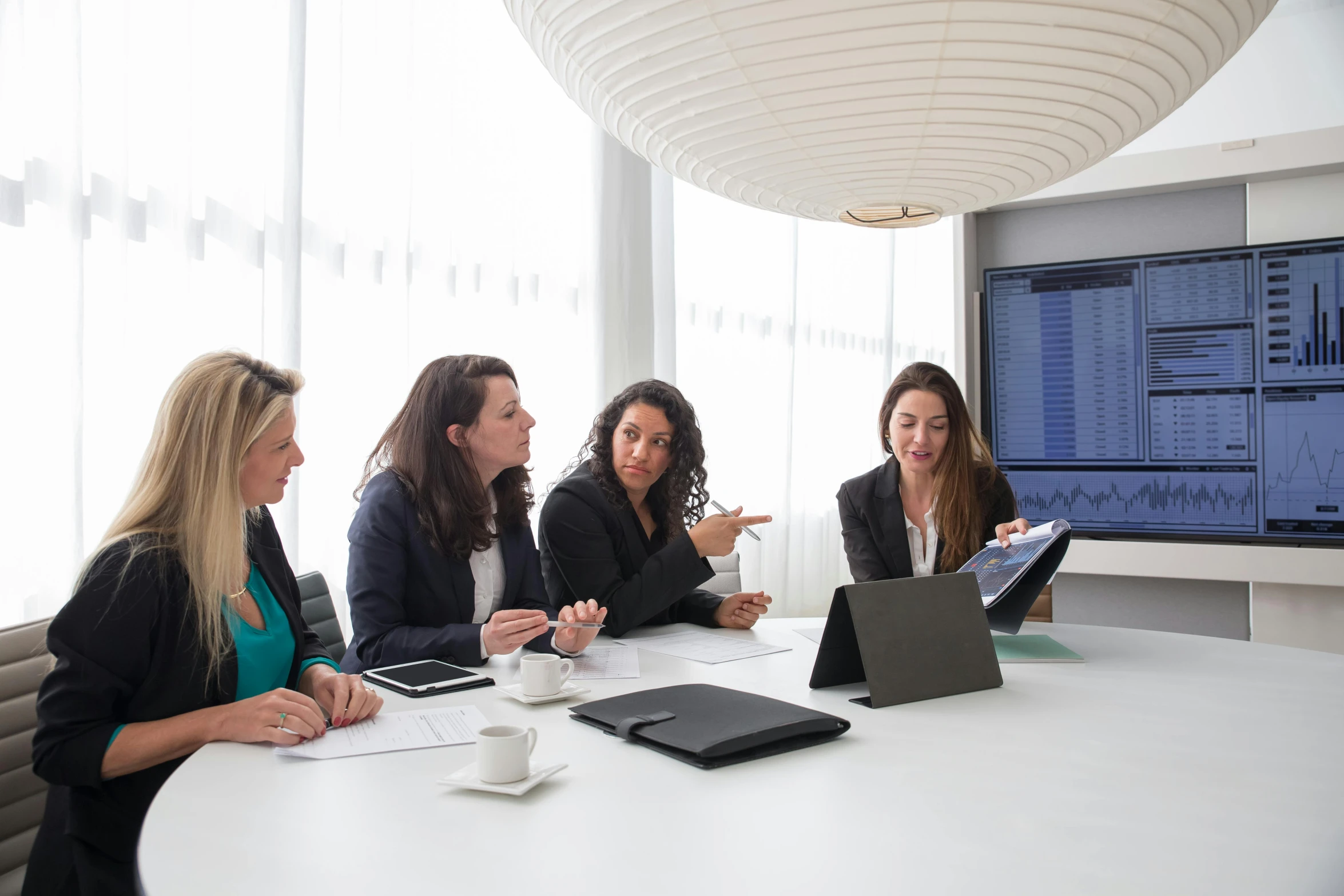 a group of four people are having a meeting