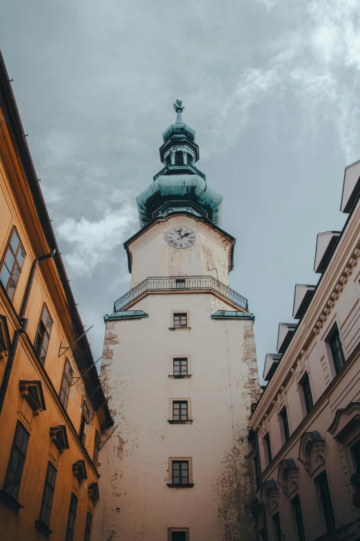 a very tall building with a tower under a cloudy sky