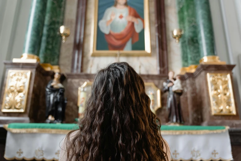 a girl in front of a statue of a virgin