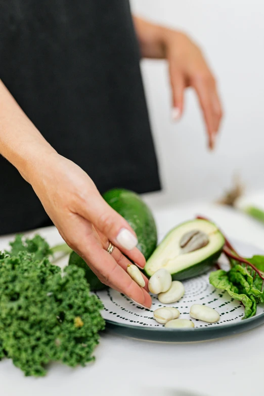 a person  up some greens on a plate