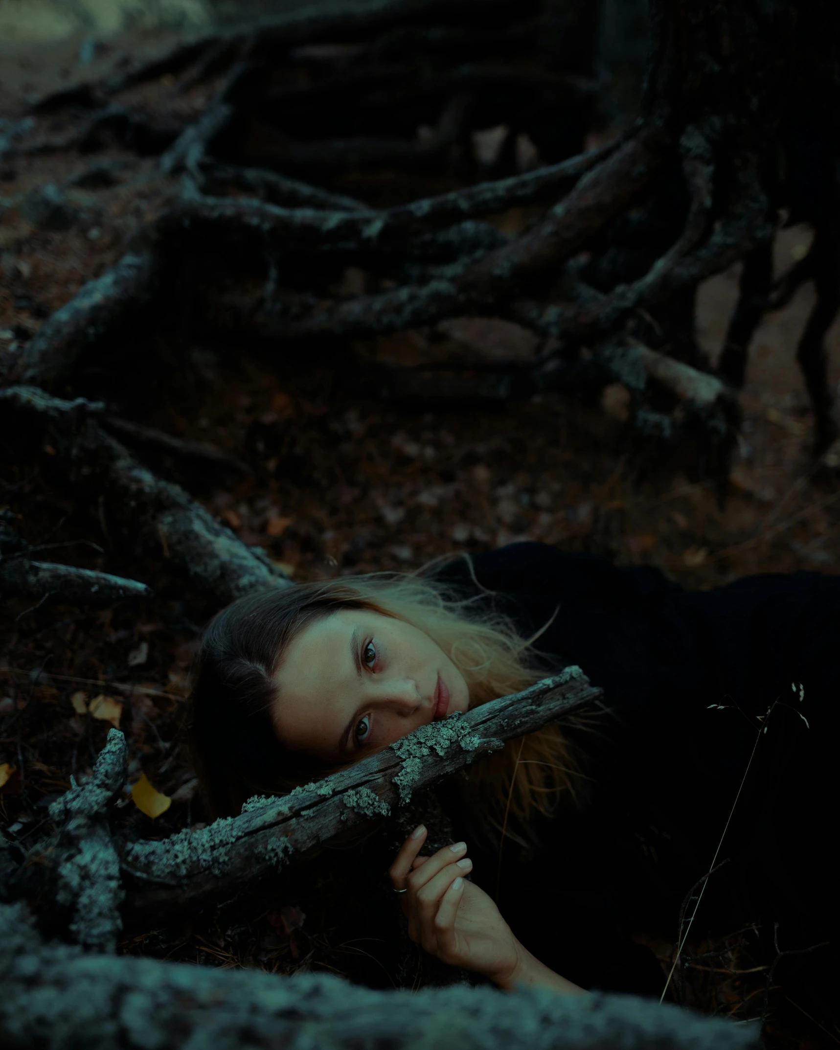 a young woman lies on the ground next to her nches