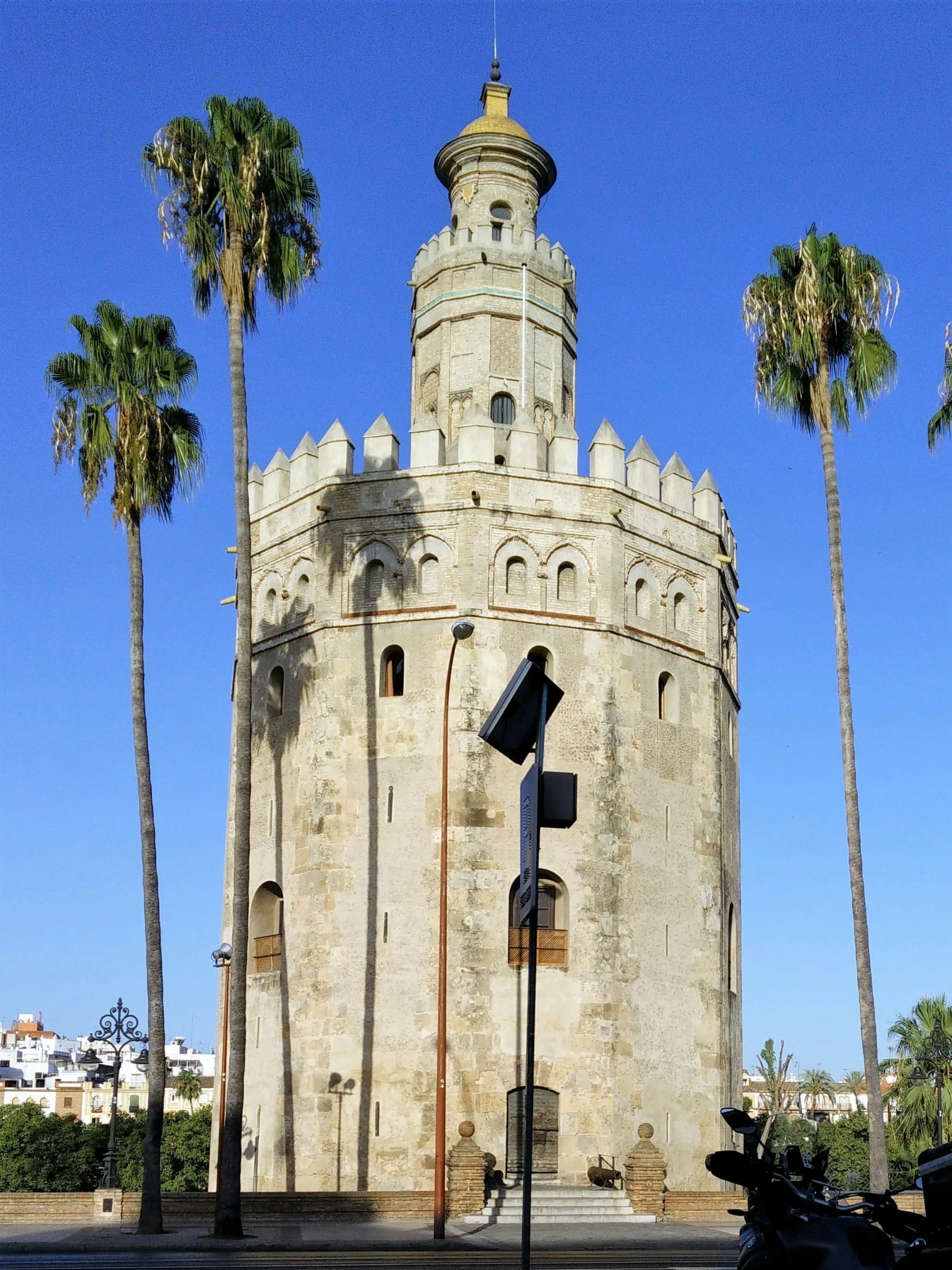 a big tower like building next to some palm trees