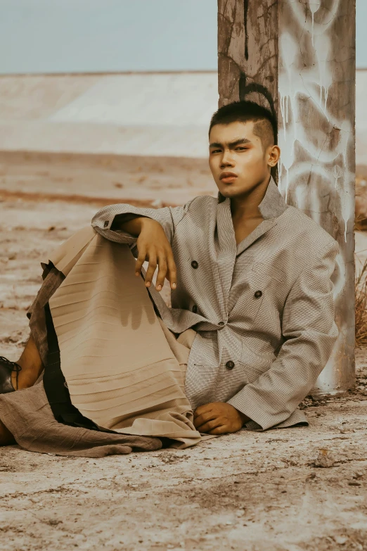 a man sitting down with a bag around his waist