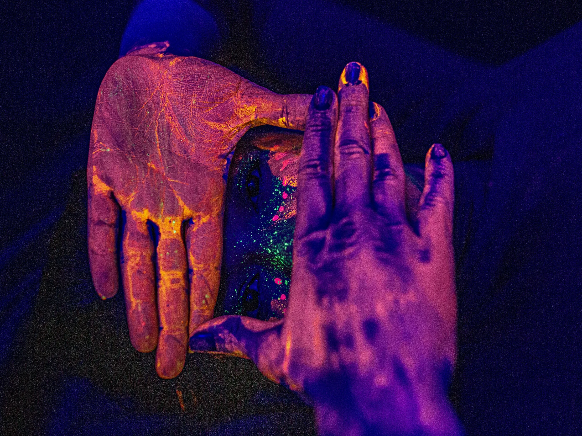 hands are shown with colored holographics against a dark background