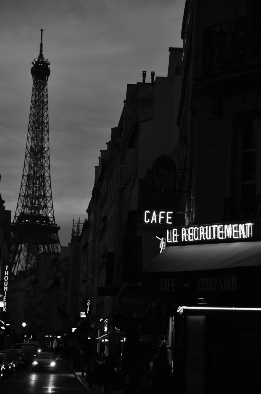 the eiffel tower sits in the background of a city street