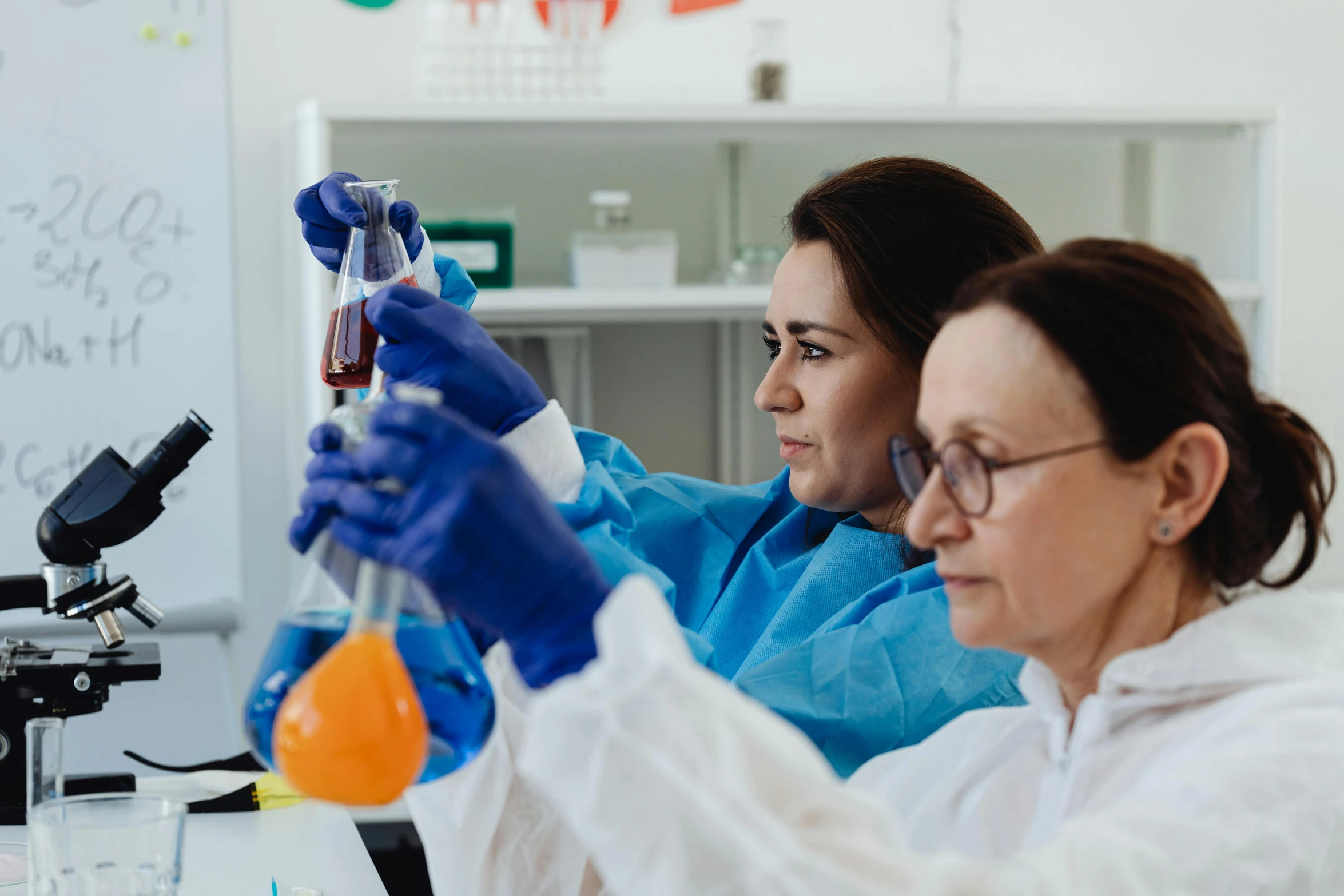 two people in a lab doing science work