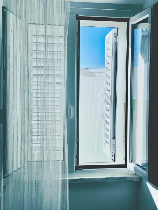 an open window is featured above a small bathroom