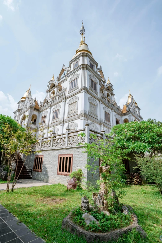 large white structure with decorative decorations and green trees