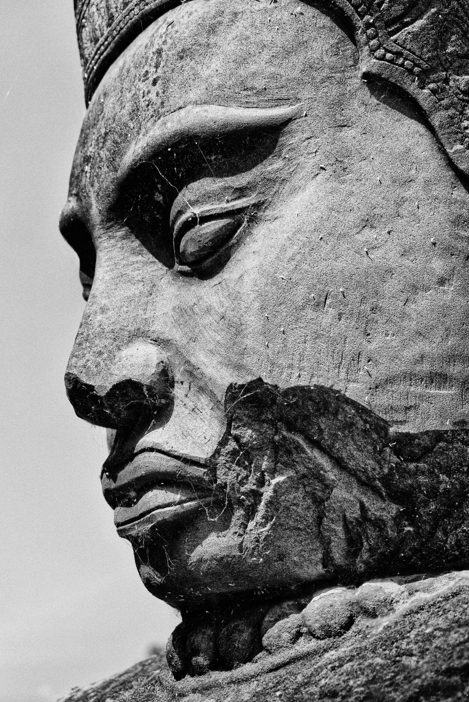 an old carving of buddha's face from the stone block