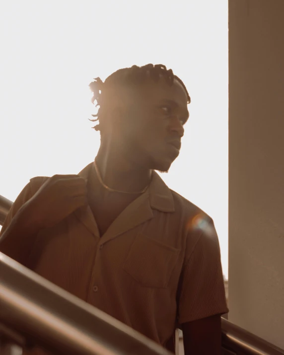 a black man standing in front of a window