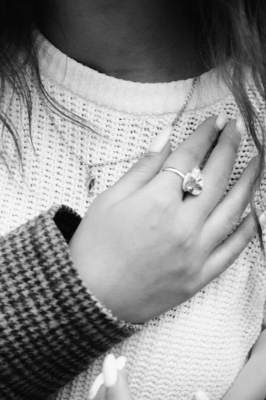 a person holding their hands together wearing a diamond ring