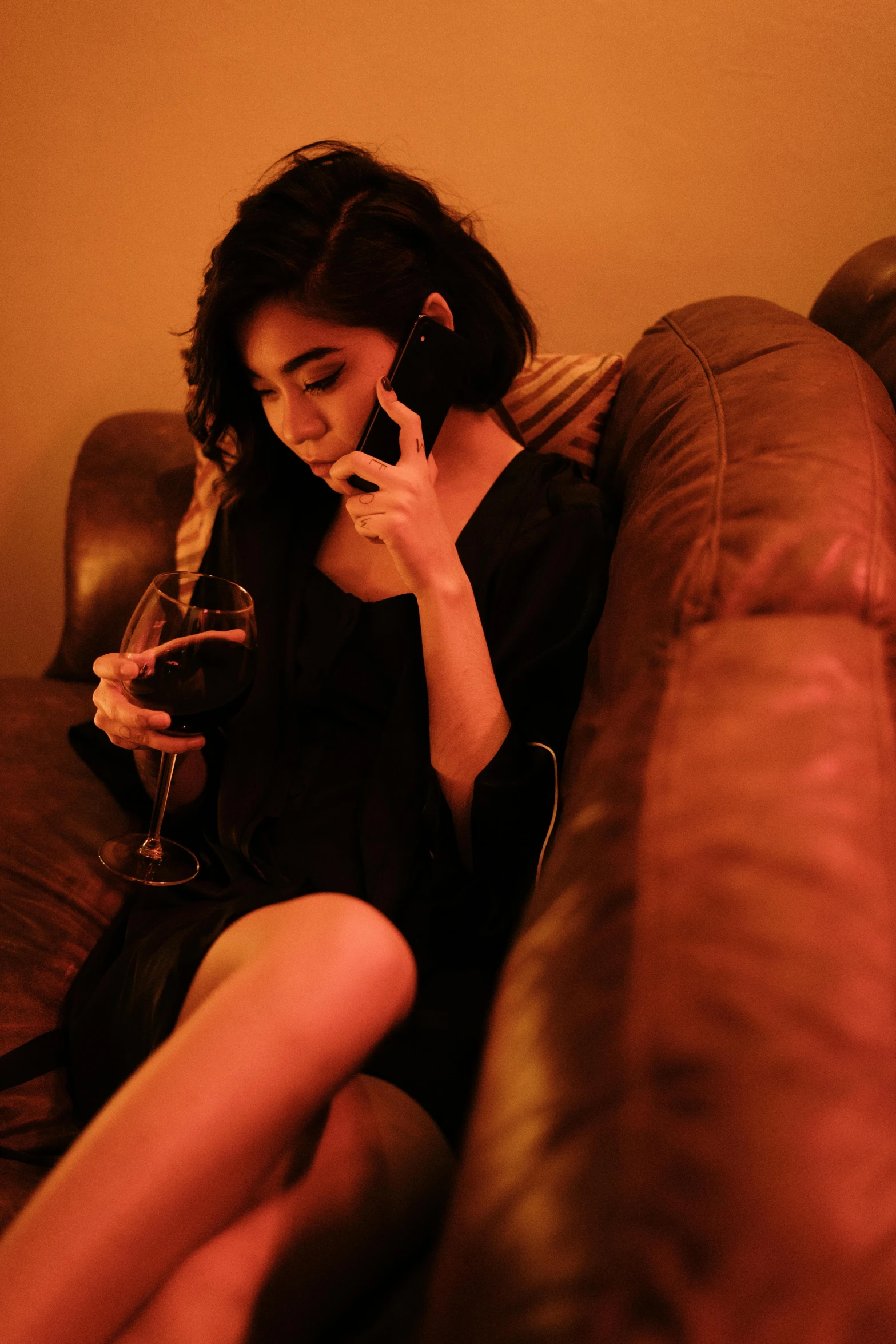 woman in a black dress on her cell phone