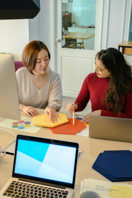 a woman is making soing in a table by a laptop