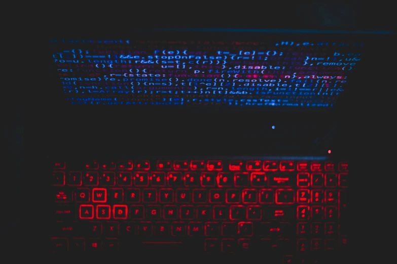 keyboard glowing in red and blue over black background