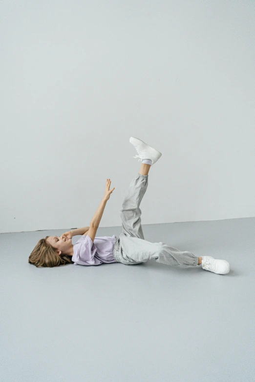 a woman lies on the floor and stretches up