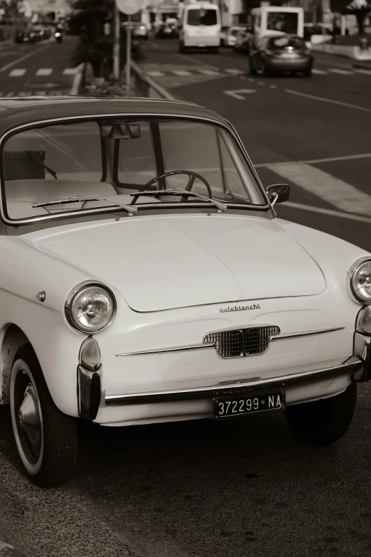 an old style car is parked in front of a gas station