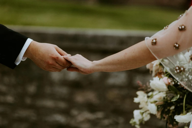 a person holding hands with someone else in hand