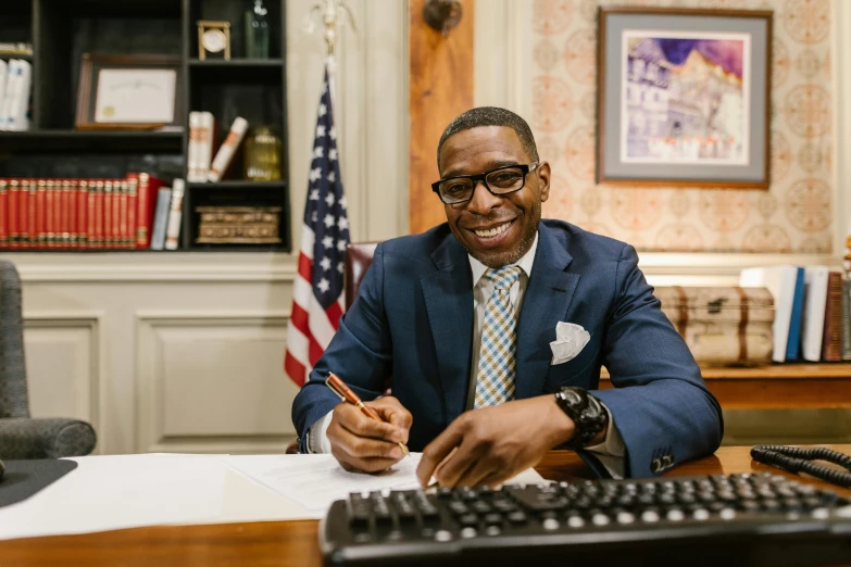 a man is at his desk with a pen