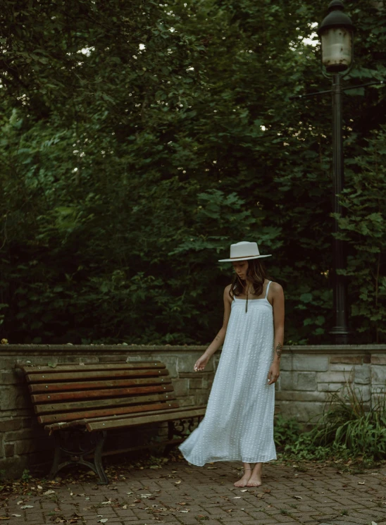 a woman in a white dress and white hat