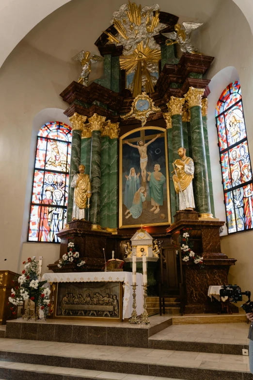 a large ornate shrine with paintings and stained glass windows