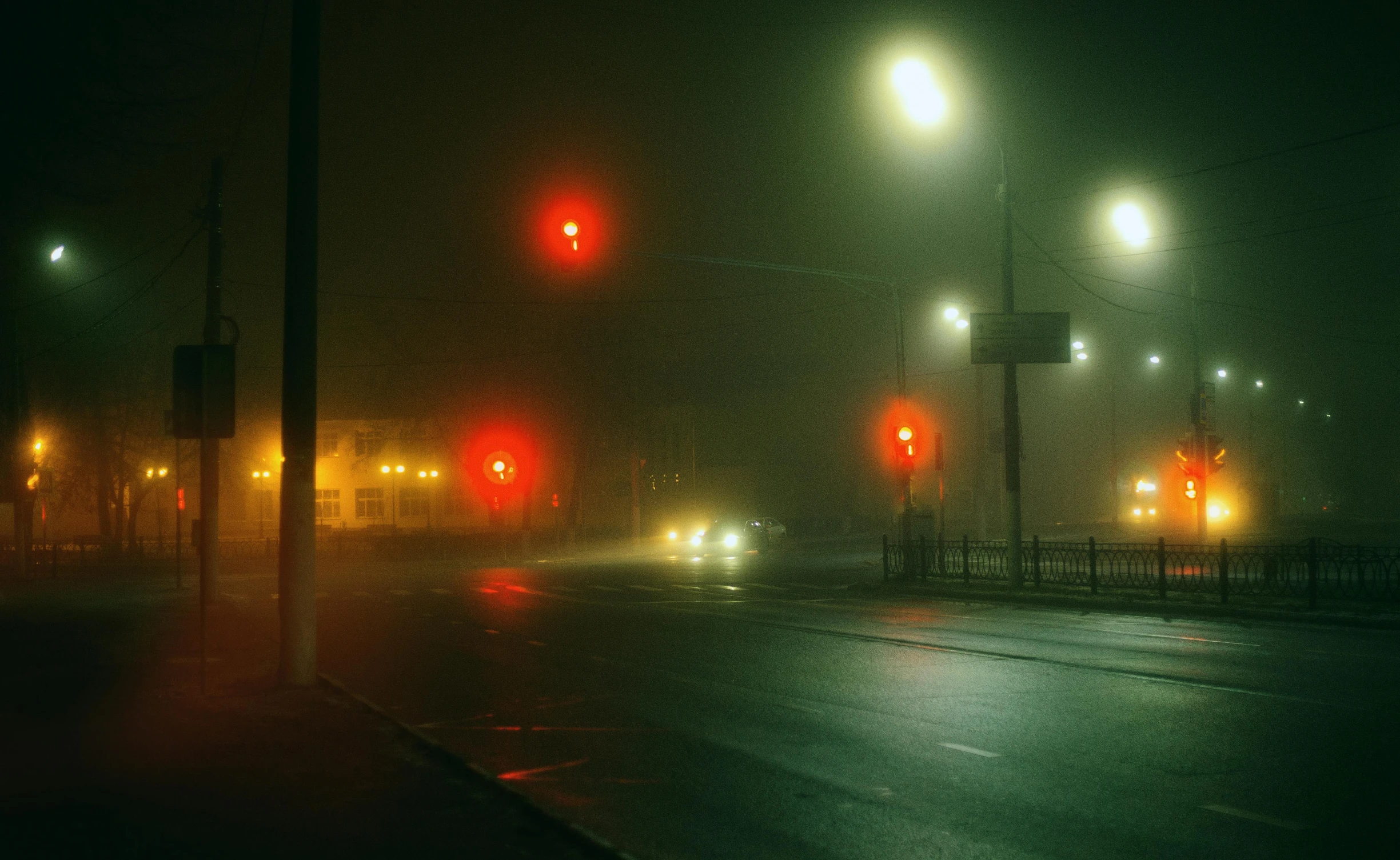 the lights on a road are glowing in the dark