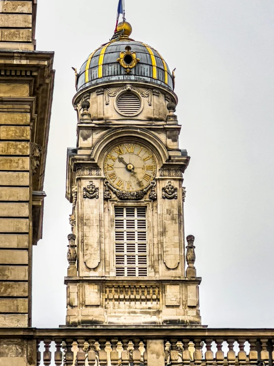 an old building has a very large clock tower