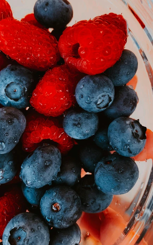 berries are mixed together in a bowl