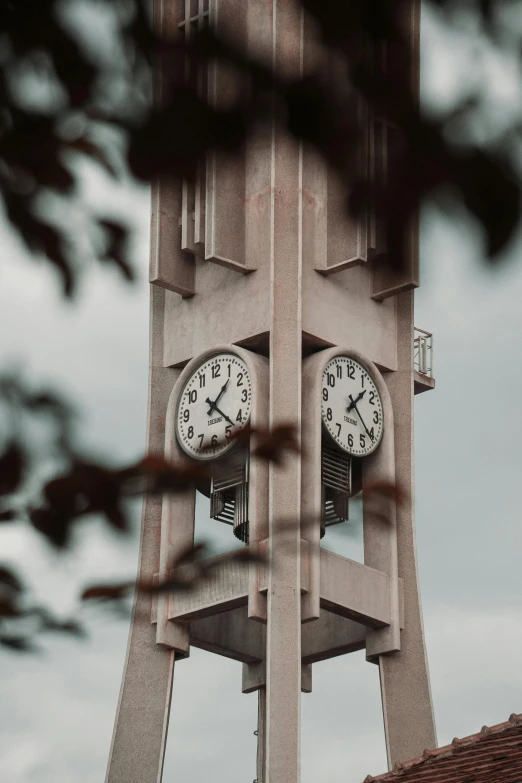 a clock tower with two clocks on each side of it