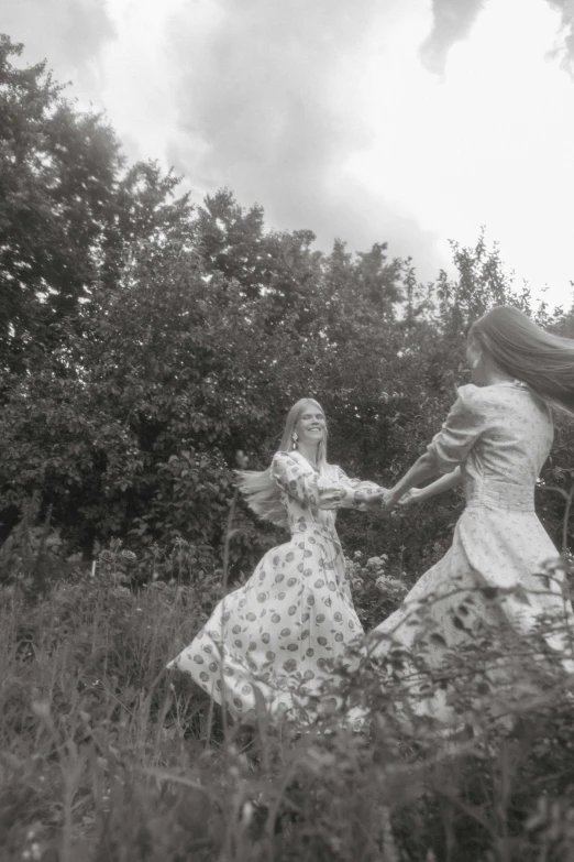 an old po of two women dancing outside in the grass